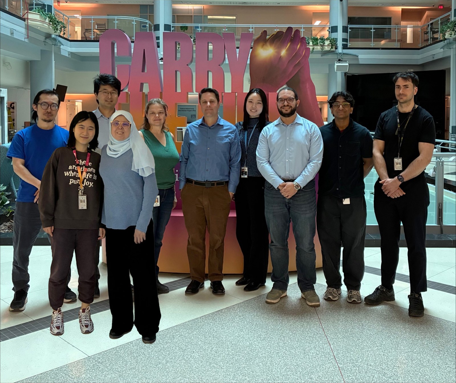 Brooks Lab group standing in front of the Carrie sign