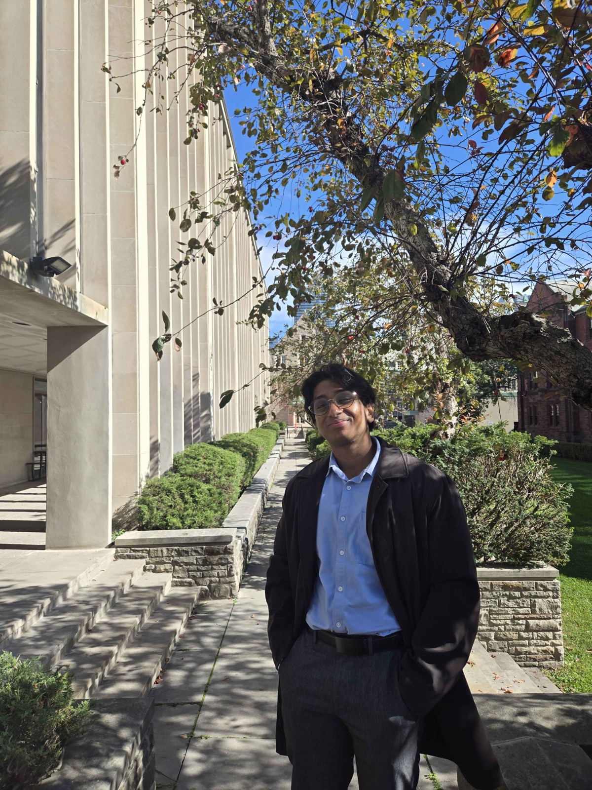Sid standing outside on campus