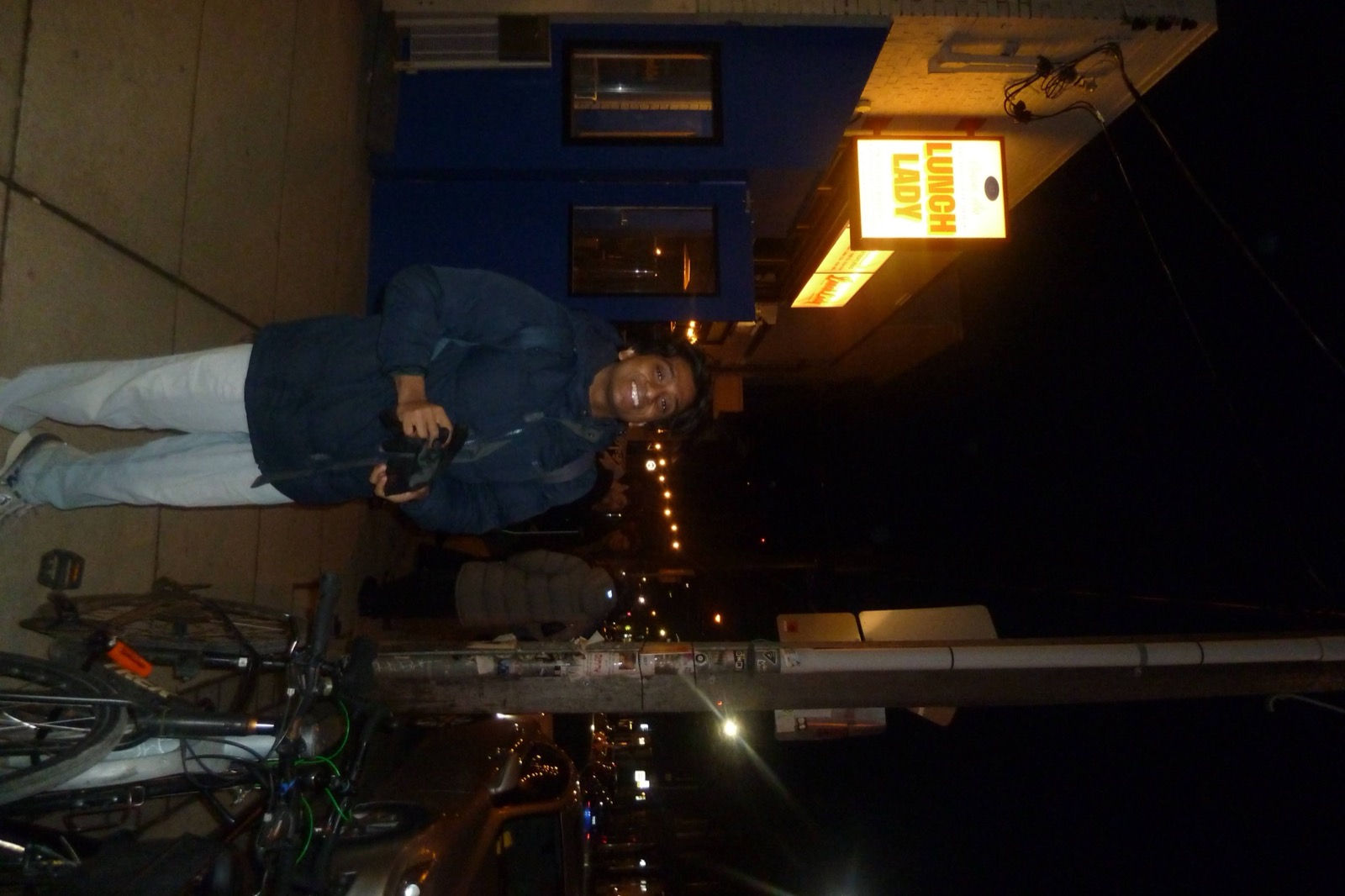 Sid standing outside Lunch Lady at night